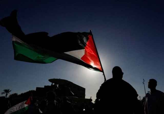 Man waving flag of the State of Palestine